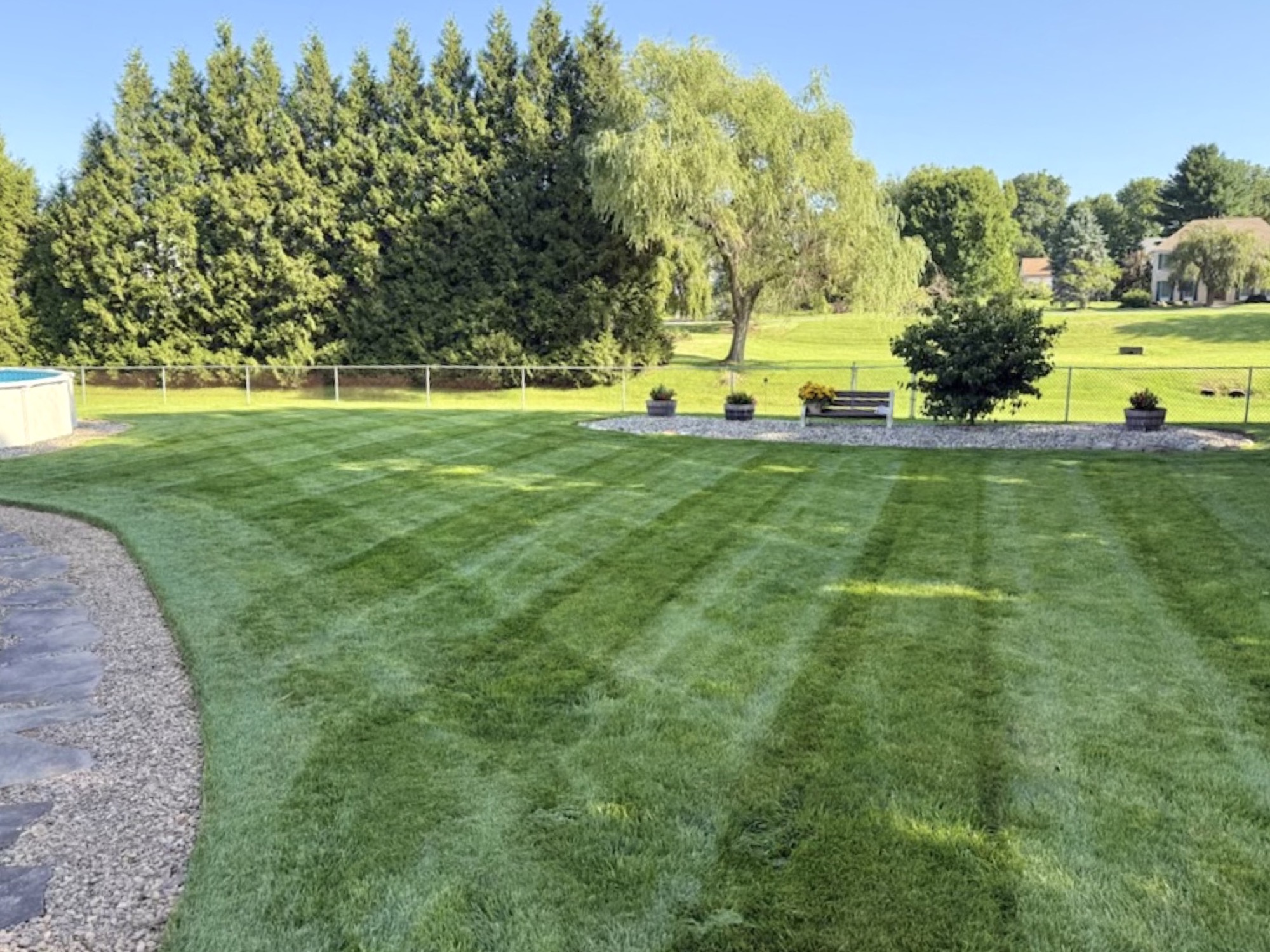 Freshly striped, healthy lawn maintained by T-Rohn's Lawncare and Landscape